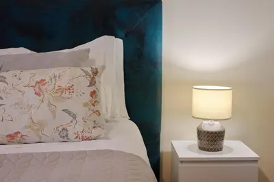 a bed with a pillow and a lamp on a night stand at Mon Coin Dans La Ville by Homie in Funchal