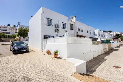 a car parked in front of a white building at Newly renovated 2 bedroom townhouse - close to Salema Beach in Salema