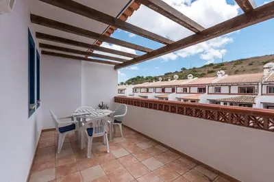 a balcony with a table and chairs and a view at Casa dos Sonhos in Luz