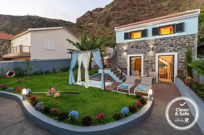 a house with a garden in front of it at Cottage Pearl - Rural Holiday Experience by SeaPearl in Paul do Mar