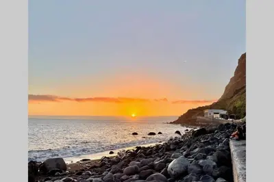 a sunset on a rocky beach with the ocean at Cottage Pearl - Rural Holiday Experience by SeaPearl in Paul do Mar