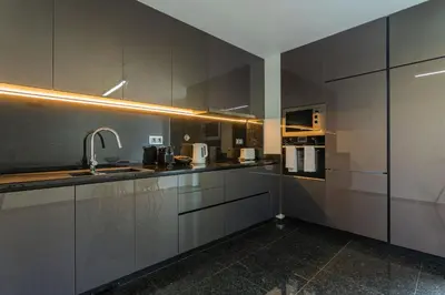 a kitchen with stainless steel cabinets and a sink at FLH Funchal Balcony Flat with Pool in Funchal
