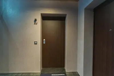 a hallway with a brown door in a building at FLH Funchal Balcony Flat with Pool in Funchal