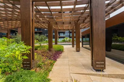 a wooden pergola over a walkway in a building at FLH Funchal Balcony Flat with Pool in Funchal
