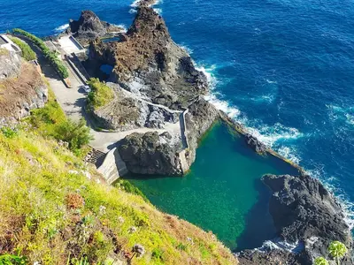 an aerial view of a cliff with the ocean at Ninho Gaivota in Porto Moniz