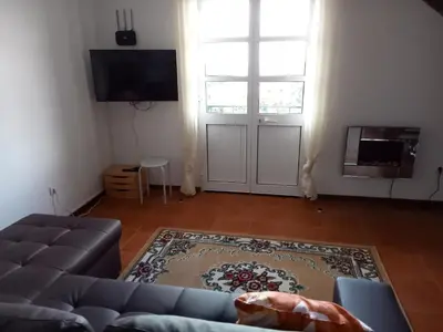 a living room with a couch and a large window at Scenic Comfort in Ponta Delgada
