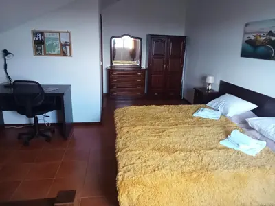 a bedroom with a bed and a desk and a computer at Scenic Comfort in Ponta Delgada