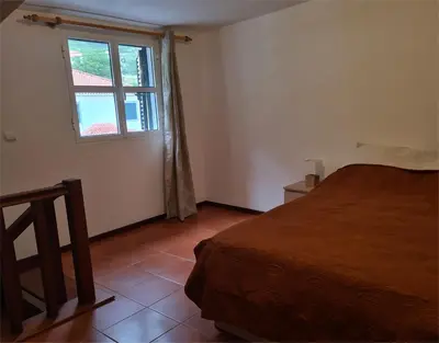 a bedroom with a bed and a window at Scenic Comfort in Ponta Delgada