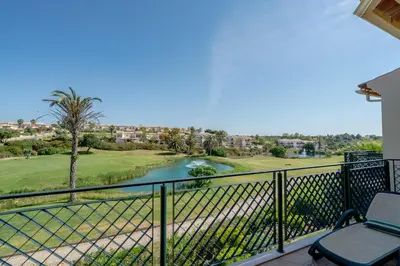 a balcony with a view of a golf course and a river at Beautiful Villa on Boavista Golf Resort - Daily Service & Spa Access in Lagos