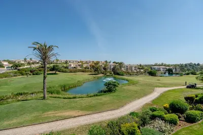 an aerial view of a golf course with a palm tree at Beautiful Villa on Boavista Golf Resort - Daily Service & Spa Access in Lagos