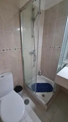 a bathroom with a shower with a toilet and a sink at Machico Comfort in Machico