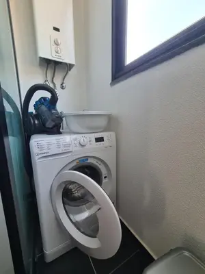 a bathroom with a washing machine and a camera at Machico Comfort in Machico