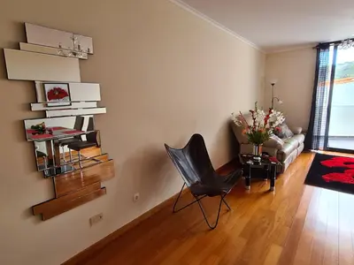 a living room with a chair and a couch at Machico Comfort in Machico