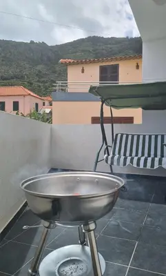 a bbq grill on the back of a balcony at Machico Comfort in Machico
