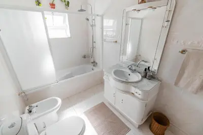 a white bathroom with a sink and a toilet at LemonTree Eco Surfhouse in Sagres