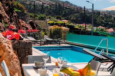 a swimming pool with a view of a mountain at OurMadeira - GrandView in Funchal