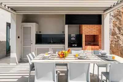 a kitchen and dining room with a table and chairs at OurMadeira - GrandView in Funchal