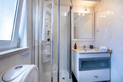 a white bathroom with a shower and a sink at Casa May - Spacious family home with great outdoors! in Aljezur