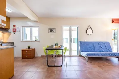 a living room with a table and a couch at Casa May - Spacious family home with great outdoors! in Aljezur
