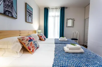 a bedroom with a bed with two towels on it at A Casa da Tia in São Vicente