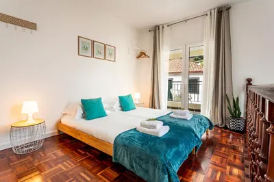 a bedroom with a bed and a large window at A Casa da Tia in São Vicente