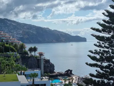 a view of a large body of water with buildings at come hear the ocean! in Funchal