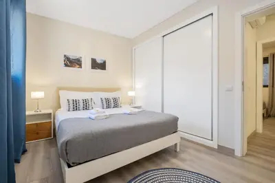 a bedroom with a bed and a large window at Coração da Madeira by Homie in Curral das Freiras