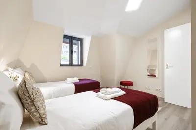 a bedroom with two beds and a window at Coração da Madeira by Homie in Curral das Freiras