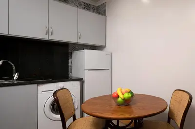 a kitchen with a table with a bowl of fruit on it at Vila do Largo by Homie in São Vicente