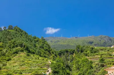 a hill with windmills on top of a mountain at Vila do Largo by Homie in São Vicente