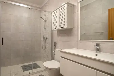 a bathroom with a shower and a toilet and a sink at Vila do Largo by Homie in São Vicente