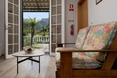 a living room with a chair and a table at Vila do Largo by Homie in São Vicente