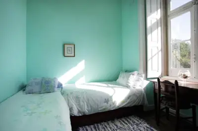 a blue bedroom with a bed and a window at Casa Grande Portugal in Burgau