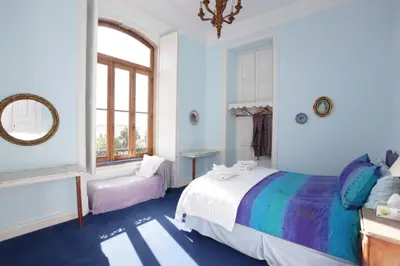 a bedroom with a large bed and a window at Casa Grande Portugal in Burgau