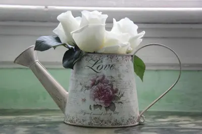 a vase with white flowers in it on a table at Casa Grande Portugal in Burgau