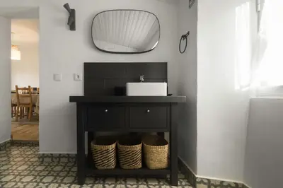 a bathroom with a white sink and a mirror at Casa do Al-gharb in Raposeira
