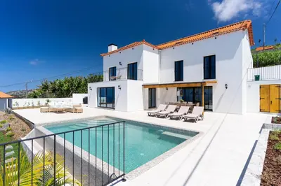 a villa with a swimming pool and a house at Villa Horizonte Azul by Holiday Rental Madeira in Ponta do Sol