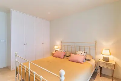 a bedroom with a bed with two pink pillows at Villa Horizonte Azul by Holiday Rental Madeira in Ponta do Sol