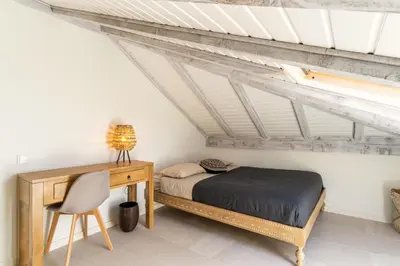 a bedroom with a bed and a desk at Villa Horizonte Azul by Holiday Rental Madeira in Ponta do Sol