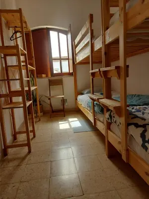 a room with three bunk beds and a window at Agua de Sonho 2 in Bensafrim