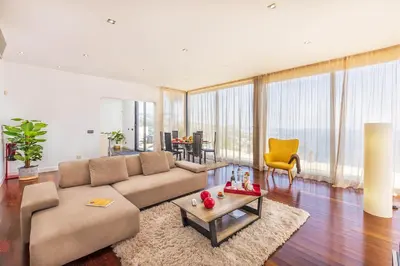 a living room with a couch and a table at Villa Amplitude in Câmara de Lobos