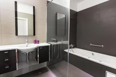 a bathroom with a sink and a shower and a bath tub at Villa Amplitude in Câmara de Lobos