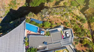an overhead view of a house with a mountain at Villa Amplitude in Câmara de Lobos