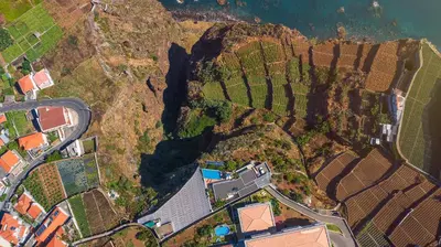 an aerial view of a house on a mountain at Villa Amplitude in Câmara de Lobos