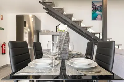 a dining room with a table with glasses and chairs at Casa Da Portada in Calheta