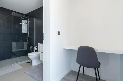 a bathroom with a toilet and a chair in it at Casa Da Portada in Calheta