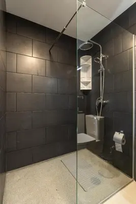 a glass shower in a bathroom with a toilet at Casa Da Portada in Calheta
