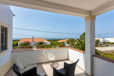 a balcony with chairs and a view of the ocean at Casa Onda - Fabulous Ocean View Villa in Aljezur