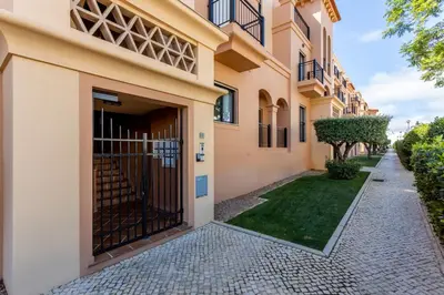 an apartment building with a gate and a walkway at Sun and Sea - Baia da Luz Apartment in Luz