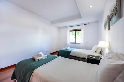 a bedroom with two beds and a window at Sun and Sea - Baia da Luz Apartment in Luz